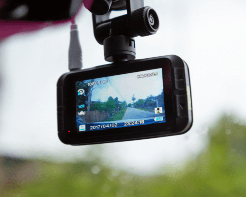 A dash cam on the inside of the windshield.
