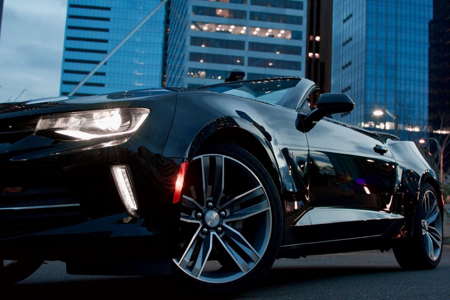 Car on road infront of tall building